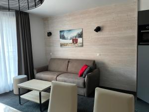 a living room with a couch and a table at Studio cabine 7 pers, piscine, animaux admis, Gourette - FR-1-860-22 in Gourette