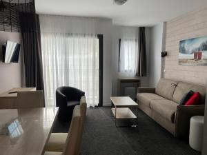 a living room with a couch and a table at Charmant studio à Gourette avec piscine et animaux admis, pour 6 personnes - FR-1-860-26 in Gourette