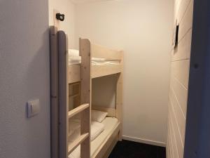 a small room with two bunk beds in it at Studio 6 pers, piscine, animaux admis - FR-1-860-28 in Gourette +3 photos