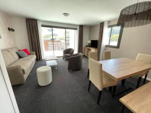 a living room with a couch and a table at Appartement à Gourette - 6 pers, Piscine, Animaux admis - FR-1-860-27 in Gourette