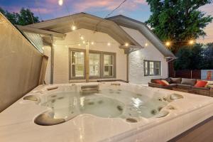 a large bath tub in front of a house at 5 Beds Downtown OKC - Pickleball, Hot Tub, Firepit, GameRoom in Oklahoma City +51 photos