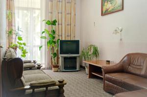 a living room with a couch and a tv at Filvarki-Centre in Kamianets-Podilskyi