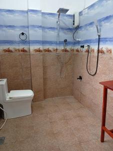 a bathroom with a shower and a toilet at freedom house in Unawatuna