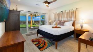 a bedroom with a bed and a large window at SUNSET BREEZE Breezy 3BR Ainamalu Home for Large Families in Waikoloa +57 photos