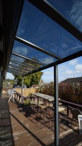 a group of tables and chairs on a deck at Redwoods Lodge - 6BR & 6BA - Large Groups - Free Parking in Rotorua