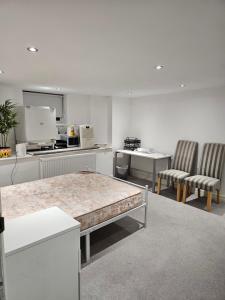 a kitchen with two chairs and a table in a room at Oxford Studios in Altrincham