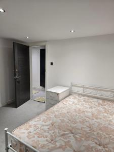 a bedroom with a bed and a dresser in it at Oxford Studios in Altrincham