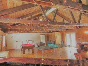 a room with two ping pong tables in a building at Charming Cabin Retreat in the Foothills of the Adirondacks in Fort Ann, New York in Fort Ann