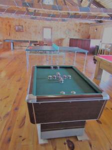 a pool table in a room with two tables at Charming Cabin Retreat in the Foothills of the Adirondacks in Fort Ann, New York in Fort Ann +31 photos