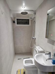 a small bathroom with a toilet and a sink at Oxford Studios in Altrincham