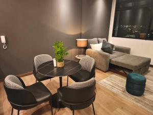 a living room with a table and chairs and a couch at Sense Coliving Ecuador Residences & Convention in Quito +81 photos