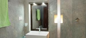 a bathroom with a white sink and a mirror at MN House in Unawatuna +39 photos