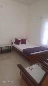 Postel nebo postele na pokoji v ubytování Pampatheeram Pallipurathucherry