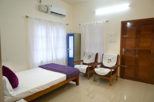 Postel nebo postele na pokoji v ubytování Pampatheeram Pallipurathucherry