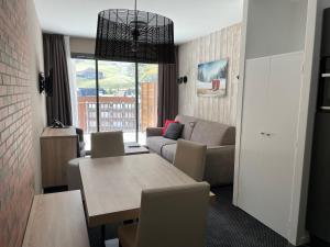 a living room with a couch and a table at Studio à Gourette avec piscine, 4 pers, animaux acceptés - FR-1-860-56 in Gourette +1 photo