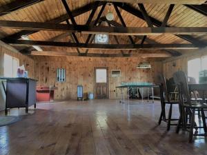 a large room with a table and chairs in it at Charming Cabin Retreat in the Foothills of the Adirondacks in Fort Ann, New York in Fort Ann