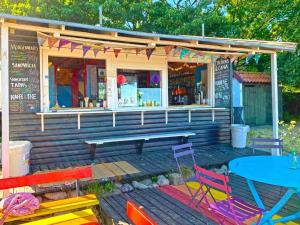 a restaurant with a picnic table and chairs in front of it at 4 person holiday home in Svaneke in Svaneke