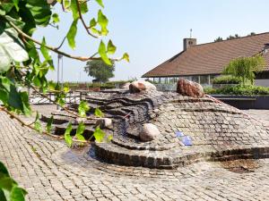 a stone fire pit on a brick road at Holiday home on a holiday park in Karrebæksminde in Karrebæksminde