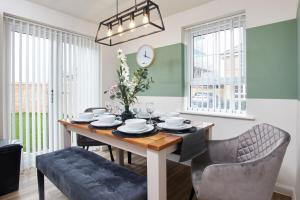 a dining room with a table and chairs at Central Coventry Stay, 3BR, Sleeps 9, Free Parking in Canley