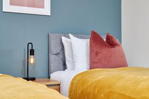 a bedroom with two beds with colorful pillows at Central Coventry Stay, 3BR, Sleeps 9, Free Parking in Canley