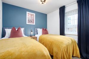 two beds in a room with blue walls at Central Coventry Stay, 3BR, Sleeps 9, Free Parking in Canley