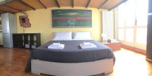 a bedroom with a large bed with two towels on it at B&B Treviglio in Treviglio