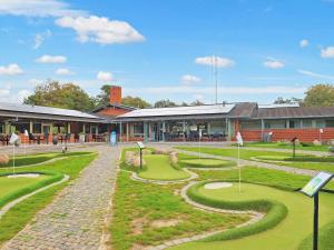 a group of golf courses in front of a building at 6 person holiday home in Gilleleje in Gilleleje