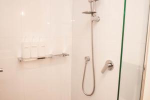 une salle de bain avec une douche avec une porte vitrée dans l'établissement Cosy modern 2BR home in the heart of Melbourne CBD, à Melbourne 15 autres photos
