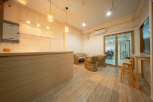 a lobby with a bar and a table and chairs at The Nook Hotel in Chiang Mai