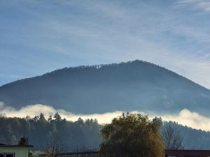 a mountain in the distance with clouds in front of it at Budget Apartment KNM5 in Kysucké Nové Mesto +5 photos