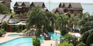 a resort with a swimming pool and palm trees at Langkawi Lagoon Floating Resort 02 in Langkawi Intl
