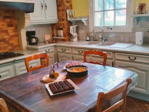 a kitchen with a table with a bowl of food on it at Gîte calme et paisible en forêt, idéal pour famille et amis - FR-1-410-486 in Le Grand-Lucé