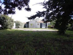 a large yard with a house in the background at Maison proche plage et centre de La Faute-sur-Mer - FR-1-194-314 in La Faute-sur-Mer