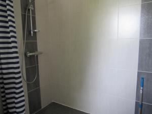 a bathroom with a shower with a glass door at Maison familiale avec jardin, à 1km de la plage - FR-1-194-308 in La Faute-sur-Mer +9 photos