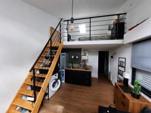 a living room with a staircase in a loft at Maisonnette rénovée proche plage avec animaux acceptés et parking - FR-1-194-319 in La Faute-sur-Mer