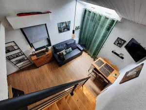 an overhead view of a living room with a couch at Maisonnette rénovée proche plage avec animaux acceptés et parking - FR-1-194-319 in La Faute-sur-Mer