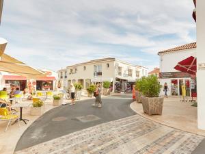 a street in a town with people walking on the street at Maison rénovée près de la plage pour 8 personnes avec jardin, wifi et parking - FR-1-194-324 in La Tranche-sur-Mer