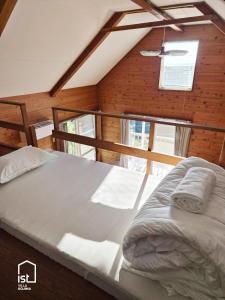 a large bed in a room with a window at ist villa 03 Seaside Cabin Sleeps 5 in Bizen
