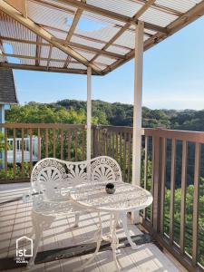 a patio with a table and chairs on a balcony at ist villa 03 Seaside Cabin Sleeps 5 in Bizen +23 photos
