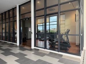 a gym with windows and exercise bikes in a building at MKH Boulevard 2, Kajang in Kajang