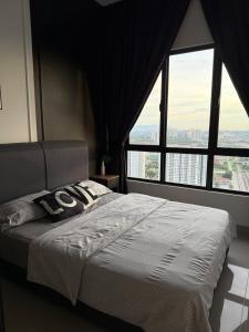 a bedroom with a large bed with a large window at MKH Boulevard 2, Kajang in Kajang +5 photos