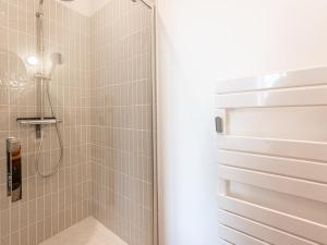 a bathroom with a shower with a glass door at Maison de charme à La Flotte, 6 personnes, rénovée avec terrasse - FR-1-835-35 in La Flotte +24 photos