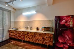 a kitchen with a counter and a refrigerator at Private Pool 3BHK Villa near Candolim in Goa
