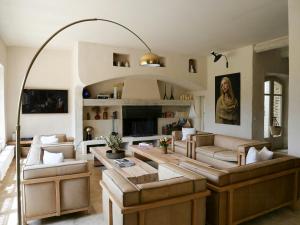 a living room with a couch and a table at Stunning Stone House With Pool Near Gordes in Gordes