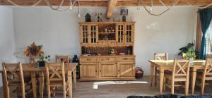 a dining room with wooden tables and a wooden cabinet at Sądelska Chałpa in Murzasichle