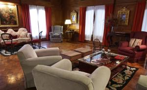 a living room with couches and chairs and a piano at Solar De La Plaza in Salta