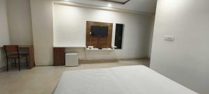 Postel nebo postele na pokoji v ubytování Hotel O Green Orch