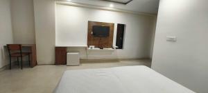 Postel nebo postele na pokoji v ubytování Hotel O Green Orch