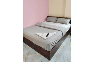 a bed with a white napkin on top of it at Hotel O Laxmi Grand in Dhundgol +8 photos