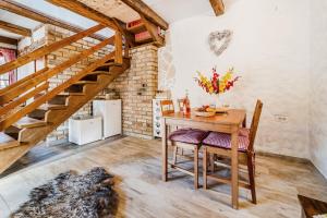a dining room with a wooden table and stairs at Nature Lodge With Sauna and Hot Tub - Happy Rentals in Tužno